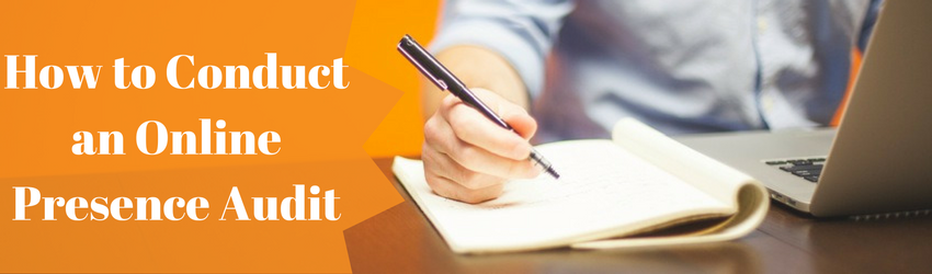 person looking at computer and writing in notebook